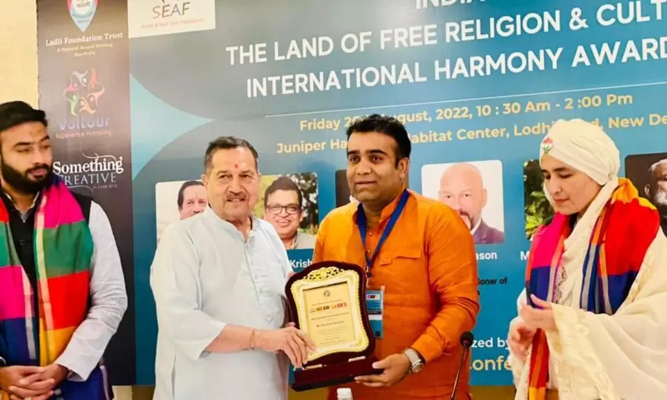 Darshan Sankhala receives the prestigious International Harmony Award on behalf of the ROLBOL Community.