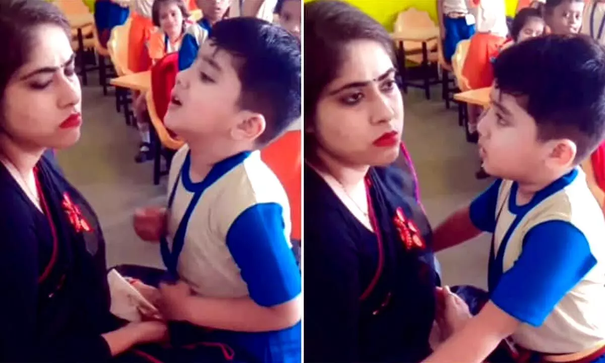 Little Boy Hugging And Apologising To His Teacher