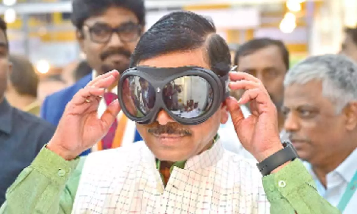Union Minister of Parliamentary Affairs, Coal and Mines of India Prahlad Joshi inspects snow goggles during the inauguration of the 5th India Manufacturing Show 2022 at Bangalore International Centre in Bengaluru on Thursday