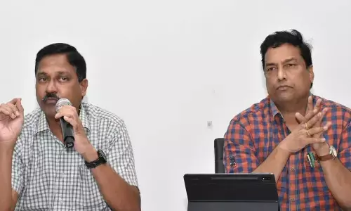 KMC Commissioner K Ramesh speaking at a review meeting at Smart City office in Kakinada on Thursday. Additional Commissioner Ch Naga Narasimha Rao is also seen.