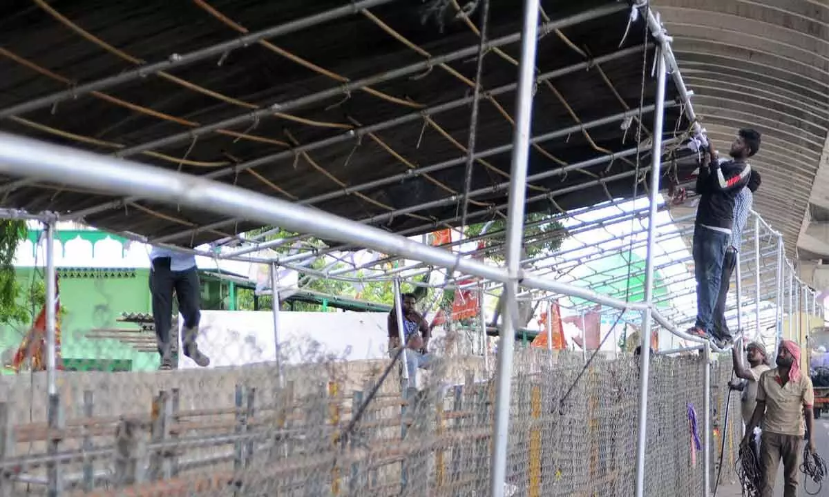 Workers erecting a queue line at Durga temple atop Indrakeeladri in Vijayawada  	Photo Ch V Mastan