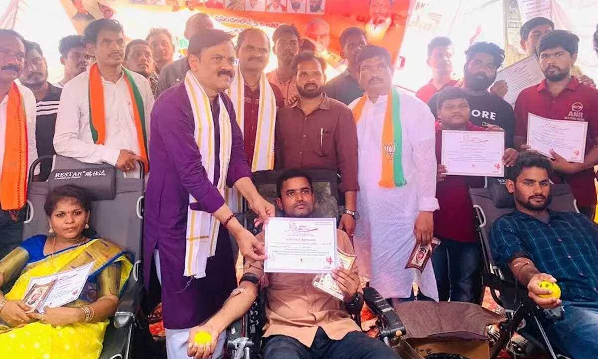BJP Rajya Sabha member GVL Narasimha Rao giving out certificates to those who took part in blood donation drive in Visakhapatnam on Saturday