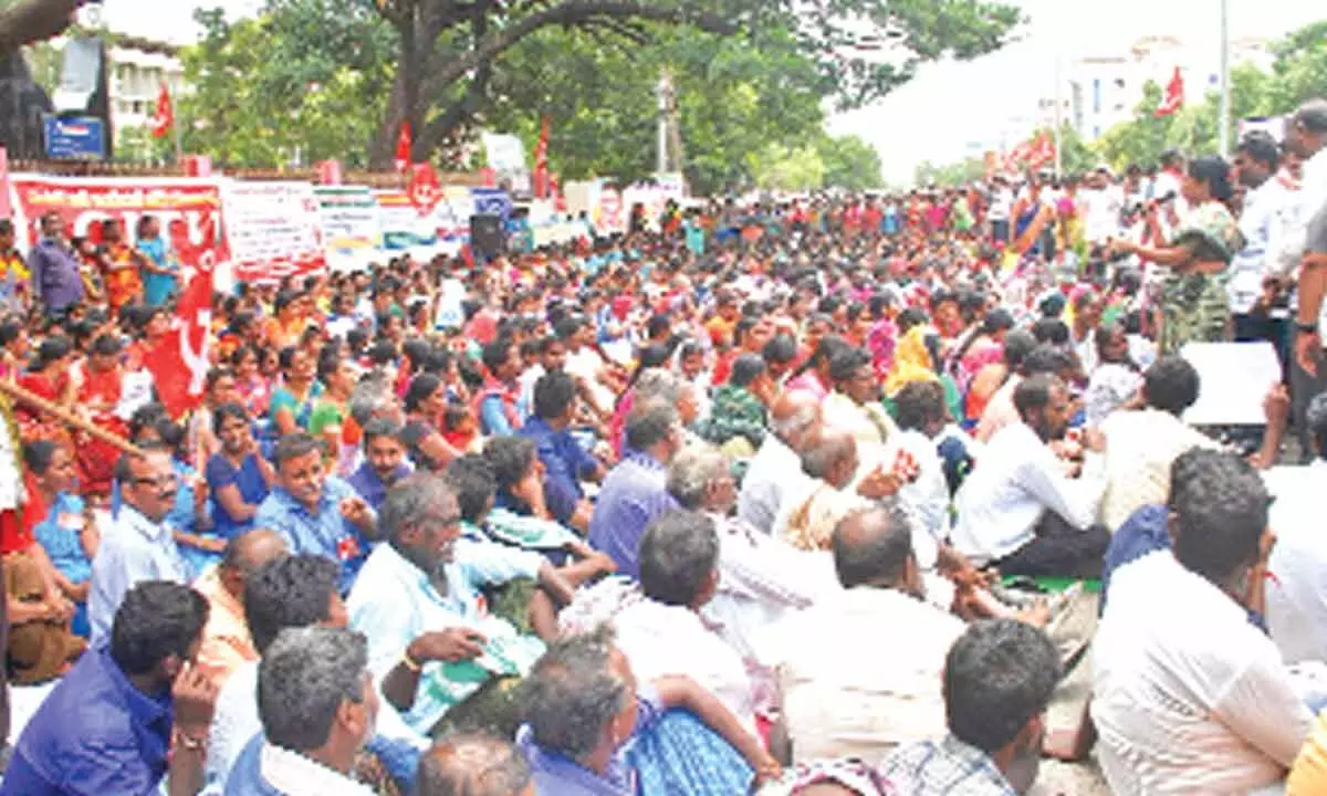 Workers and employees staging a protest at the district Collectorate in  Ongole on Tuesday