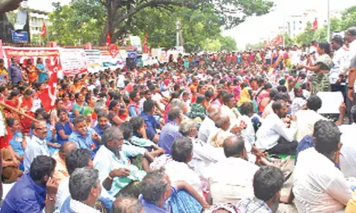 Workers and employees staging a protest at the district Collectorate in  Ongole on Tuesday