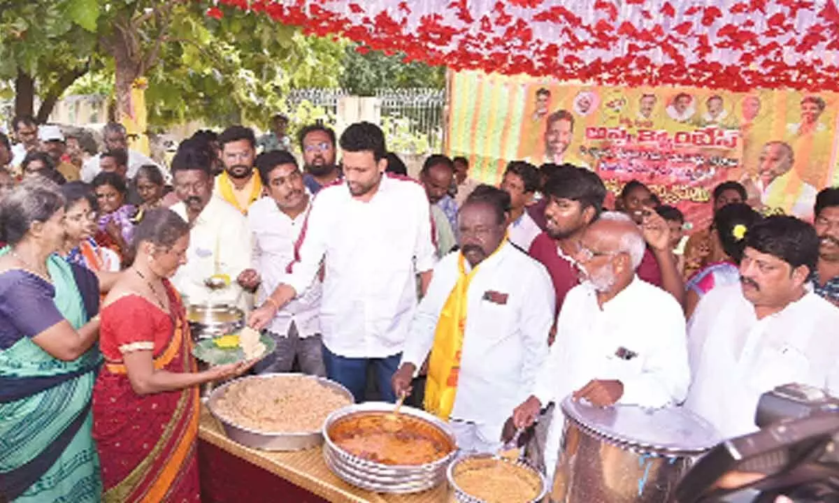 TDP Kurnool constituency in-charge TG Bharat accompanied by party’s Kurnool Lok Sabha constituency president Somisetty Venkateswarlu serving food to people after inaugurating a one-day Anna Canteen near C Camp Centre in Kurnool on Wednesday