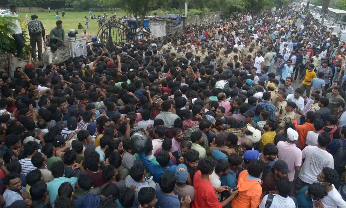 Police personnel try to disperse the fans who gathered to buy tickets for India vs Australia cricket match, following a stampede at Gymkhana Ground in Hyderabad on Thursday