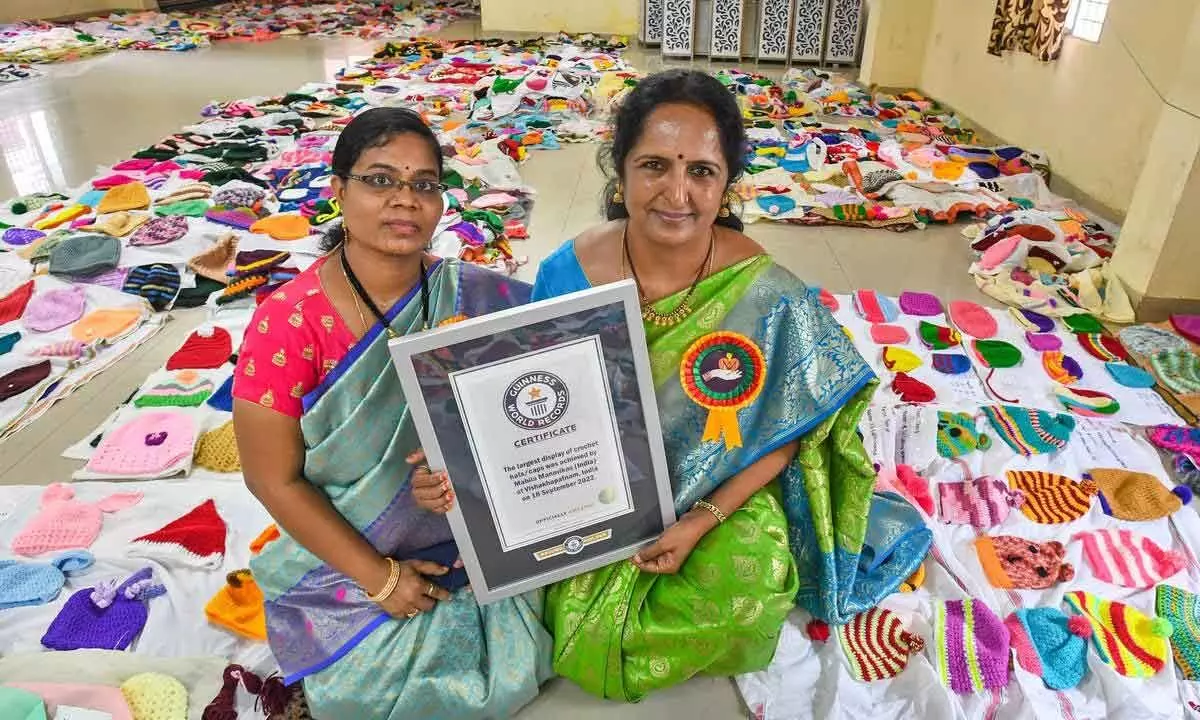 Madhavi Suribhatla (right) holding the Guinness World Record certificate for the largest display of crochet caps and hats by members of Mahila Manovika in Visakhapatnam. Around 4,000 caps were made by 200 members across the globe.