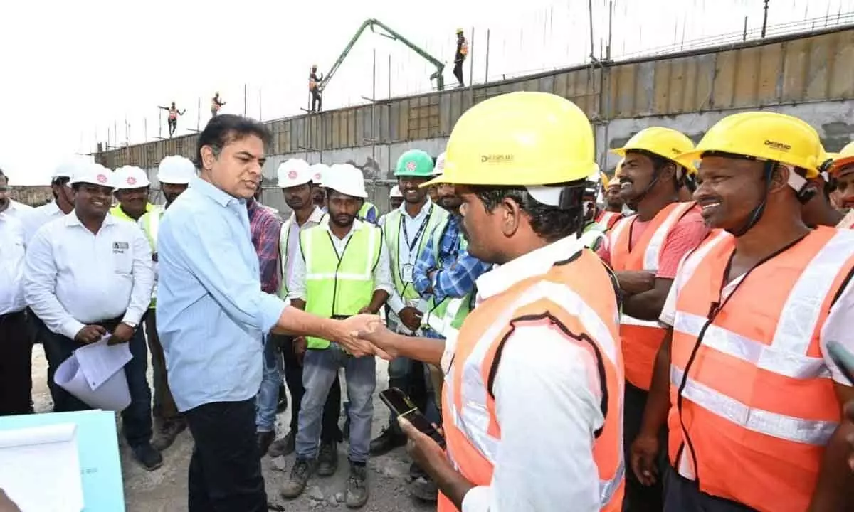 Minister KT Rama Rao having a handshake with a worker during the inspection of the under-construction Sewage Treatment Plant (STP) at Fatehnagar in Hyderabad on Saturday