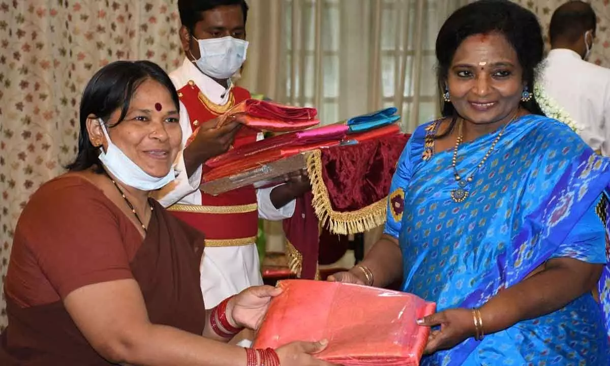 The Governor distributing  Bathukamma saree to a member of the Raj Bhavan Pariwar at Raj Bhavan in Hyderabad on Saturday