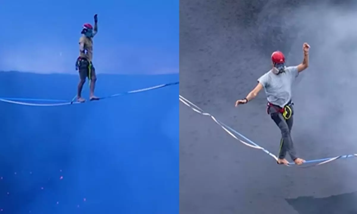 The pair was seen wearing a helmet and a gas mask while walking on the slackline.