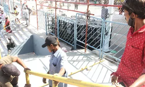 TTD staff strengthening the barricades in the Mada streets and other places ahead of Brahmotsavams, in Tirumala on Sunday