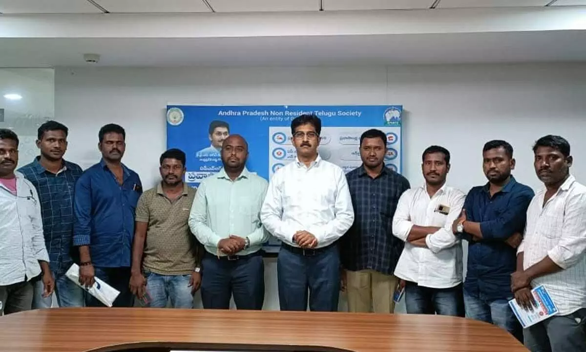The migrant workers, who returned from Oman, with APNRTS members in Vijayawada on Tuesday