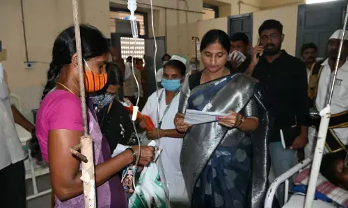 District Collector K Madhavi Latha inspecting a patient’s case sheet at Kovvuru Area Hospital in Rajamahendravaram on Wednesday