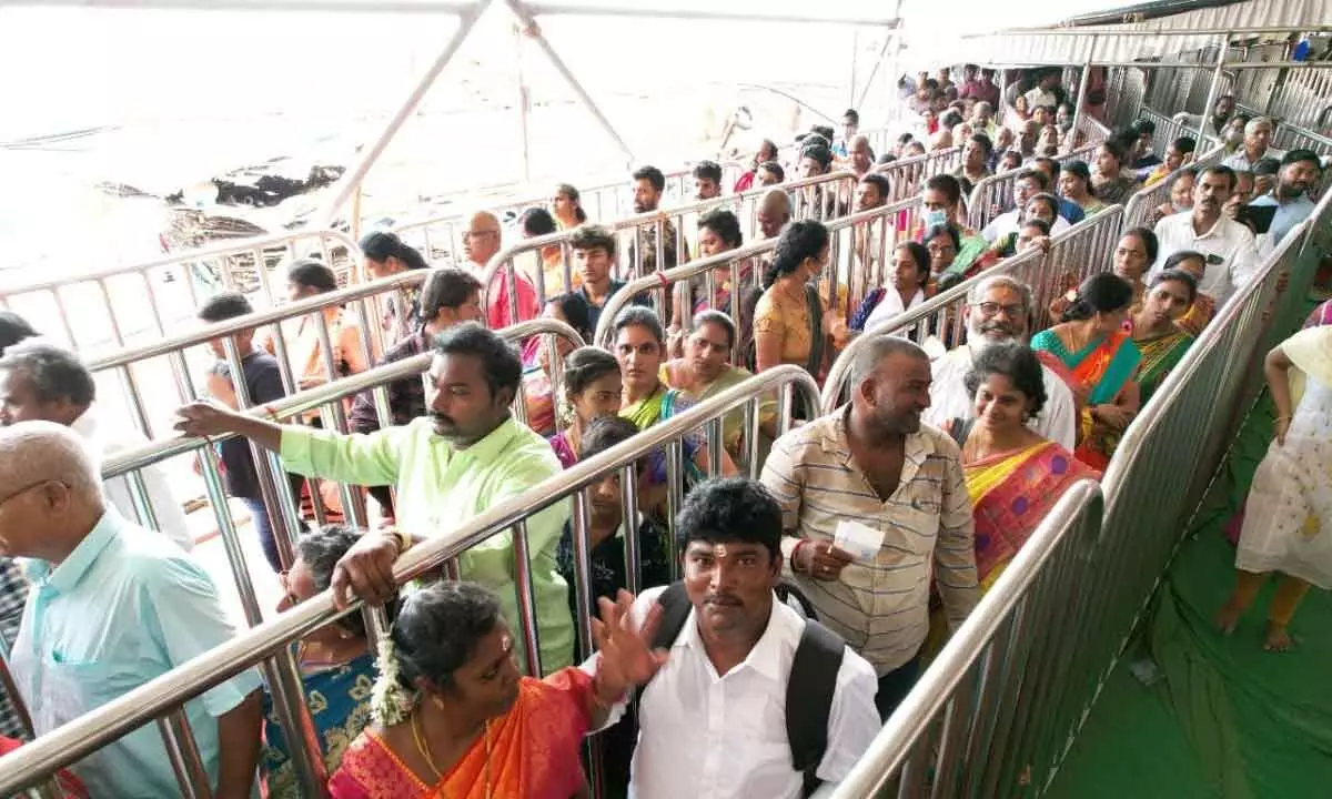 Pilgrims waiting in the queue line to have Goddess darshan at Sri Durga Malleswara Swamy temple atop Indrakeeladri on Thursday
