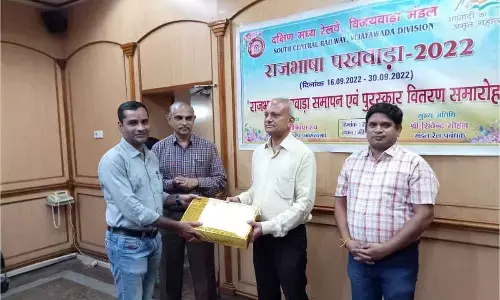 Divisional Railway Manager Shivendra Mohan giving away prize to a winner of competitions at a programme in Vijayawada on Thursday