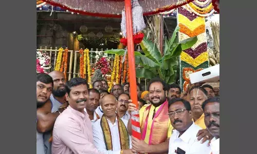 TTD EO A V Dharma Reddy receiving decorated umbrellas brought from Chennai by Hindu Dharmartha Samiti foundation founder Vedantam and Trustee RR Gopalji, for Garuda Vahana Seva in Brahmotsavams, in Tirumala on Friday.