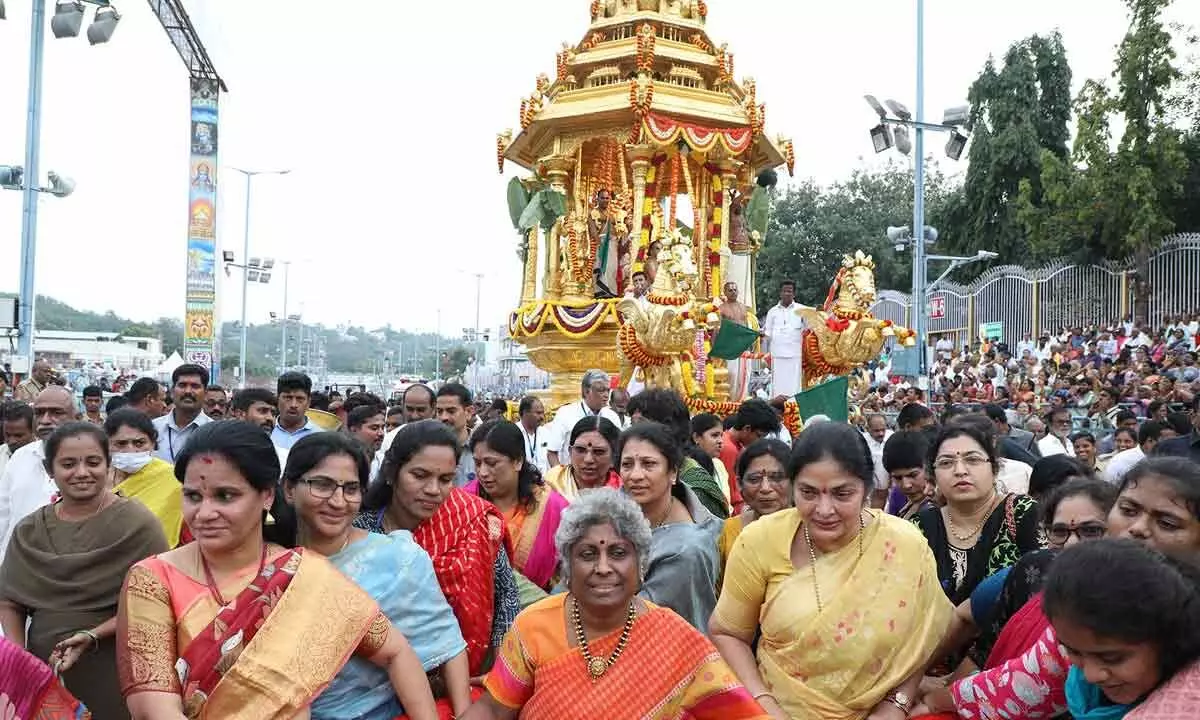 Women devotees pull the golden chariot at Tirumala on Sunday on the sixth day of Srivari Brahmotsavams