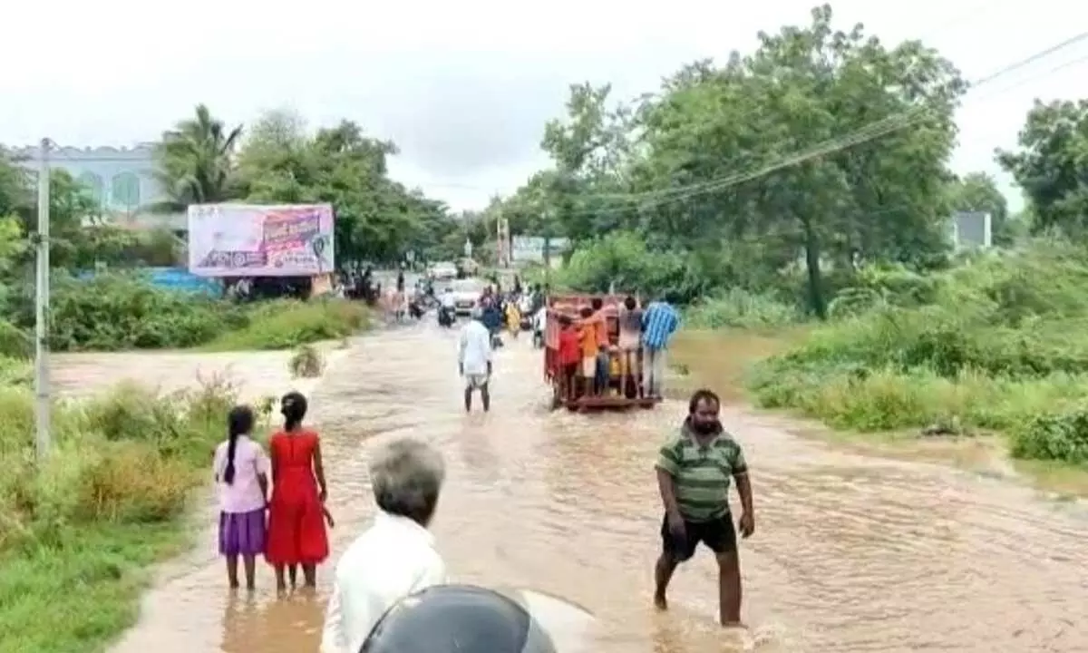 Rainwater overflowing on the chapta at Achampet in Palnadu district of Narasaraopet on Thursday