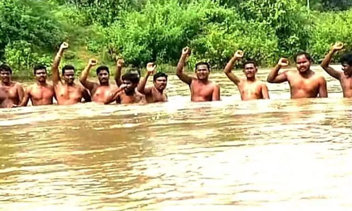 Tribals from Lingapuram village staging a Jaladeeksha in Anakapalli district on Friday