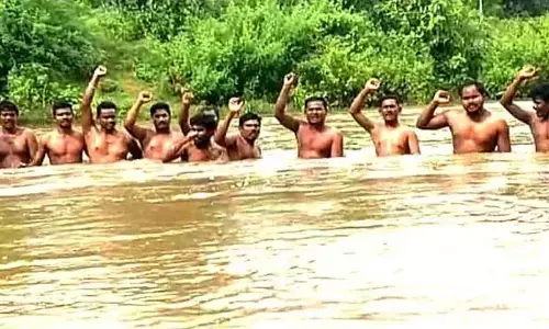 Tribals from Lingapuram village staging a Jaladeeksha in Anakapalli district on Friday
