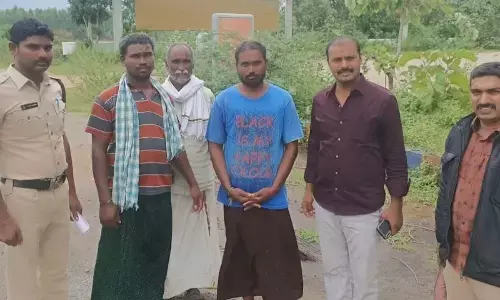 Police team with the youth Naresh (wearing blue  T shirt), who was saved from committing suicide, in Tirupati on Sunday