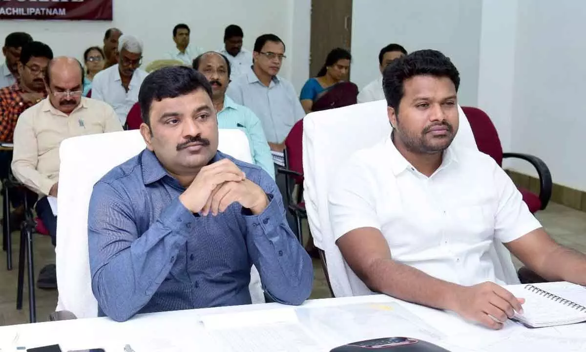 District Collector P Ranjith Basha (left) and Joint Collector V Mahesh Kumar attending a videoconference from his office in Machilipatnam on Thursday
