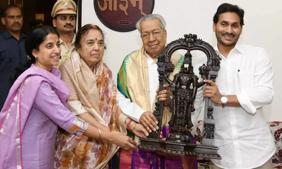 Chief Minister YS Jagan Mohan Reddy and his wife Y S Bharati present an idol to Governor Biswabhusan Harichandan and his wife during their meet at Raj Bhavan in Vijayawada on Thursday