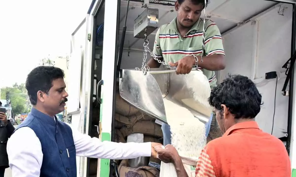 District Collector S Dilli Rao checking the distribution of PDS rice through mobile ration shop at Fakeergudem in Vijayawada on Thursday