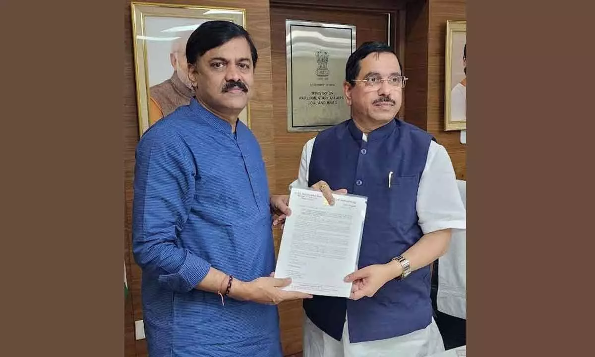 BJP MP GVL Narasimha Rao handing over a letter to Minister for Coal and Mines Pralhad Joshi
