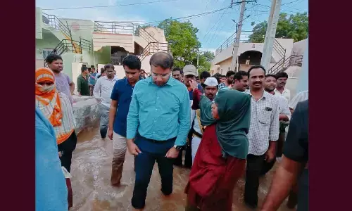 Joint Collector Garg listening to peoples woes in water logged Janasakthinagar in Anantapur on Thursday