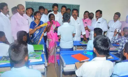Social Welfare Minister Merugu Nagarjuna interacting with the students at SC Gurukula Patasala in Sagileru village, B Kodur mandal on Thursday
