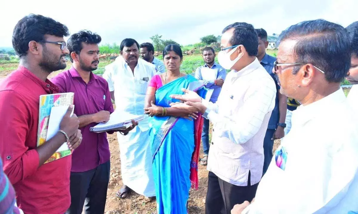 District Collector Basanth Kumar with agriculture officers near a farm in Puttaparthi on Sunday