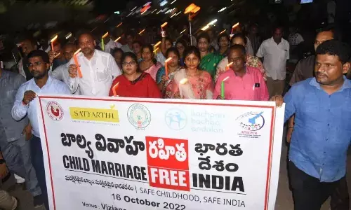 Collector A Surya Kumari and ZP Chairman Chinna Srinu taking part in candle rally in Vizianagaram on Sunday