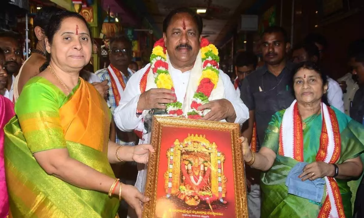 Temple EO Bramaramba presenting Goddess Durga portrait to Endowments Minister Kottu Satyanarayana at Sri Kanaka Durga temple in Vijayawada on Wednesday