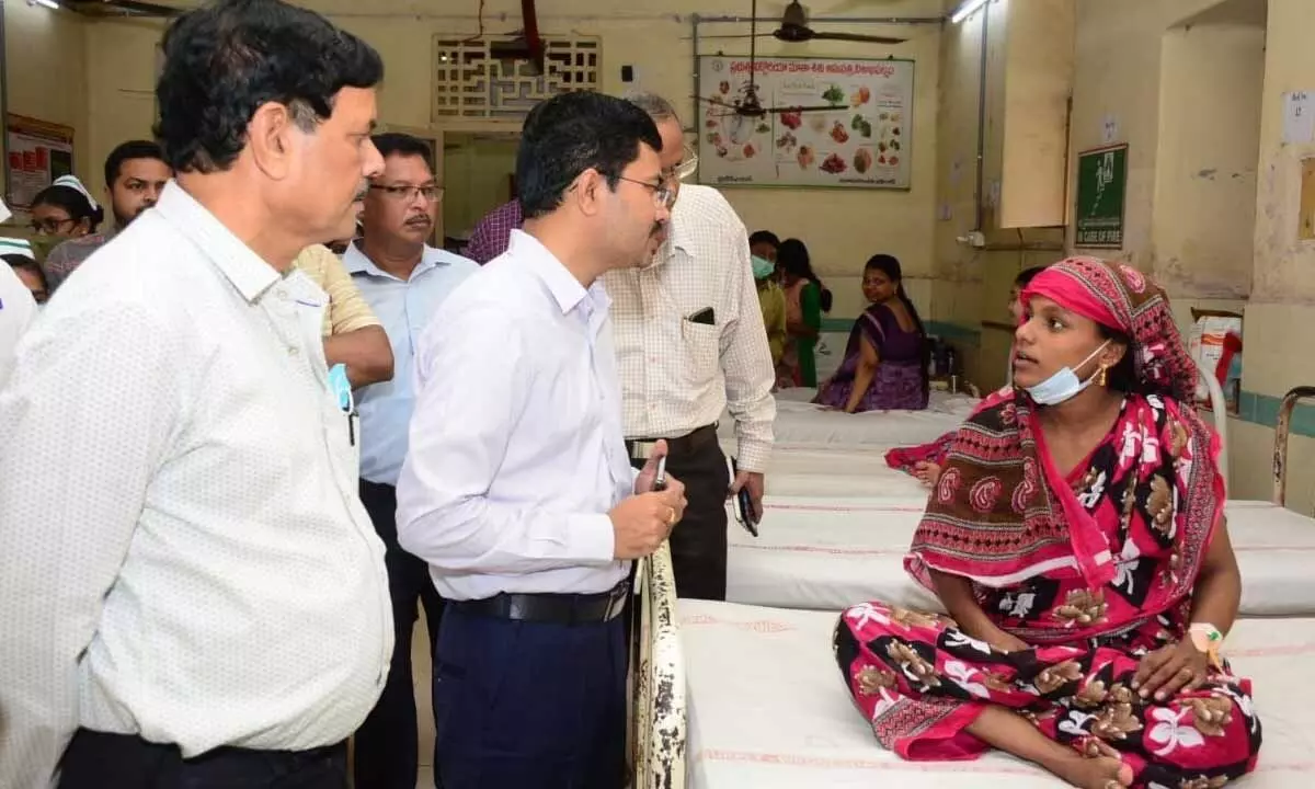 District Collector A Mallikarjuna interacting with a patient at Government Victoria Hospital in Visakhapatnam on Wednesday