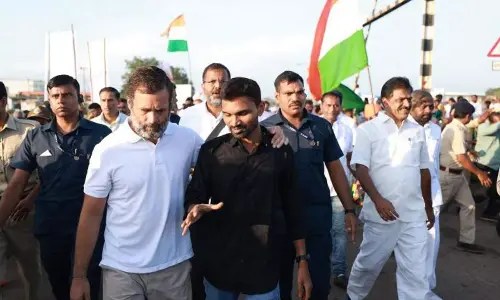3D artist Singarapu Sivaramakrishna of Manthani walking with Rahul Gandhi at Bellary in Karnataka recently