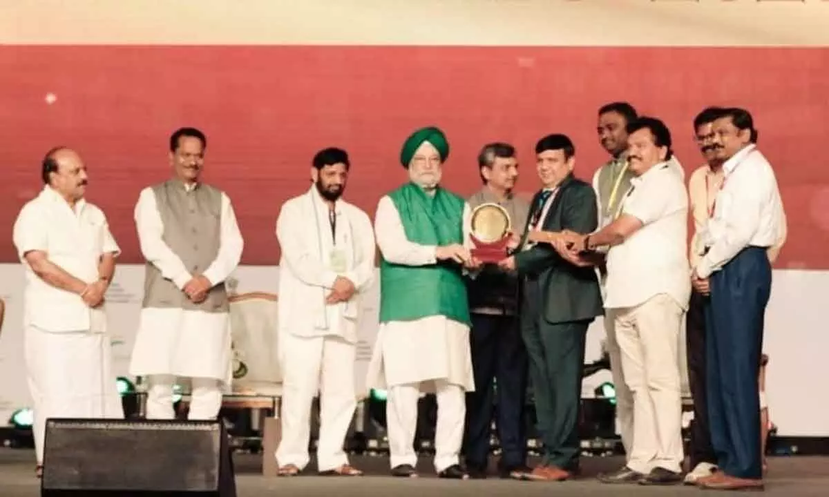 Union Minister for Urban Development and Housing Hardeep Singh Puri presenting PM Awas Yojana – Urban Award presenting to Special CS of State Housing department Ajay Jain at a programme at Rajkot in Gujarat on Thursday