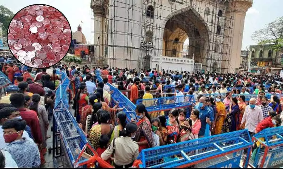 Charminars Bhagyalakshmi temple officials distribute Khazana coins to devotees