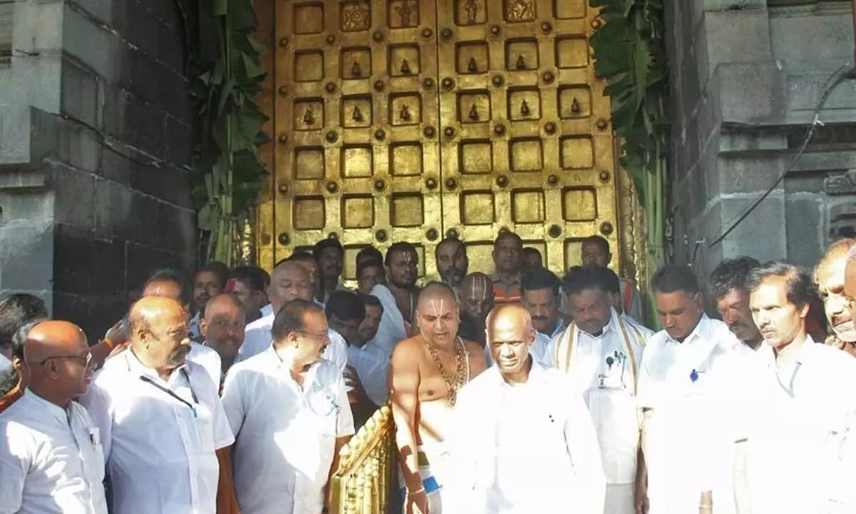 TTD Executive Officer AV Dharma Reddy, temple priests and other staff coming out after closing the shrine due to solar eclipse in Tirumala on Tuesday.