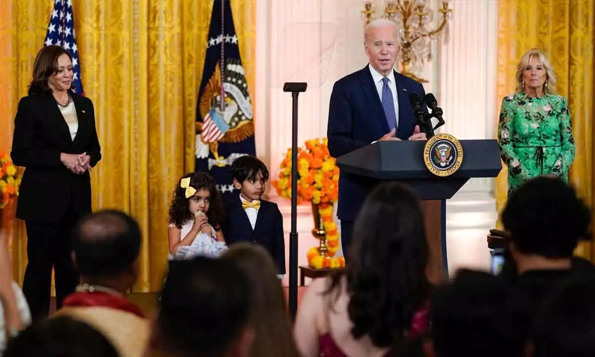 President Joe Biden speaks after inviting two children on stage during an event to celebrate Diwali, at the White House