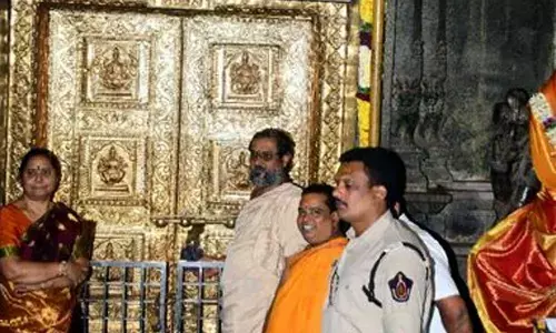 Temple executive officer D Bramaramba and priests closing Sri Durga Malleswara Swamy temple at Indrakeeladri in Vijayawada on Tuesday due to solar eclipse. Temple will be opened again from 12 pm on Wednesday (October 26)  Photo: Ch Venkata Mastan