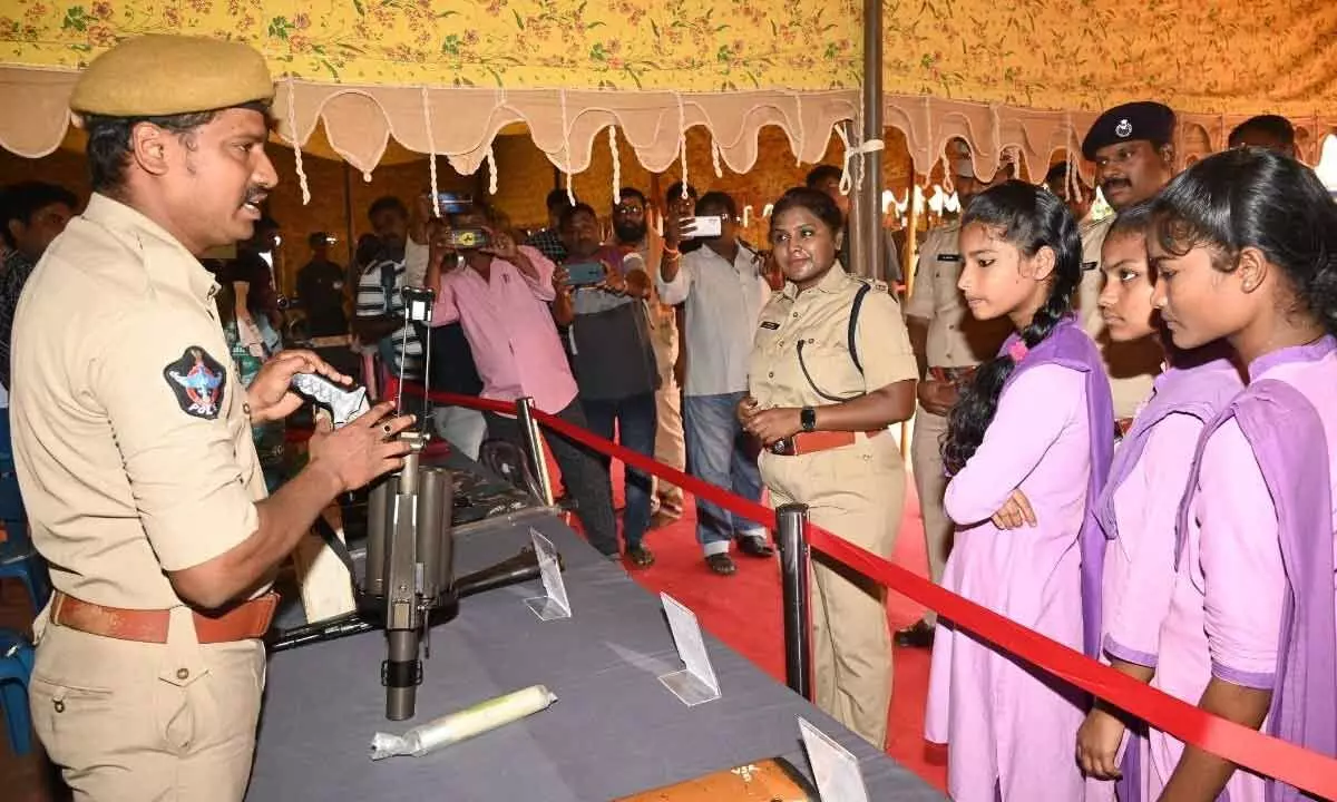A cop briefing the students about weapons in Anakapalli district on Wednesday