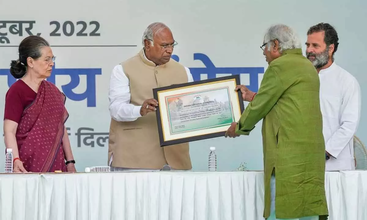 Newly-elected Congress president Mallikarjun Kharge being presented the certificate of election by Congress Central Election Authority chairman Madhusudan Mistry as former president of Congress Sonia Gandhi and party MP Rahul Gandhi look on during a ceremony at AICC headquarters in New Delhi on Wednesday