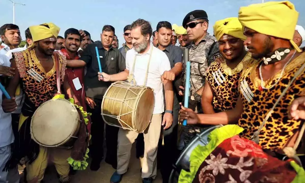 Congress leader Rahul Gandhi playing dhol with local artistes during Bharat Jodo Yatra in Makhtal in Naraynpet district on Thursday