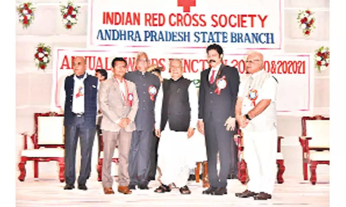 Governor and IRCS – AP president Biswabhusan Harichandan felicitating Prakasam District Collector AS Dinesh Kumar at a programme in Vijayawada on Friday