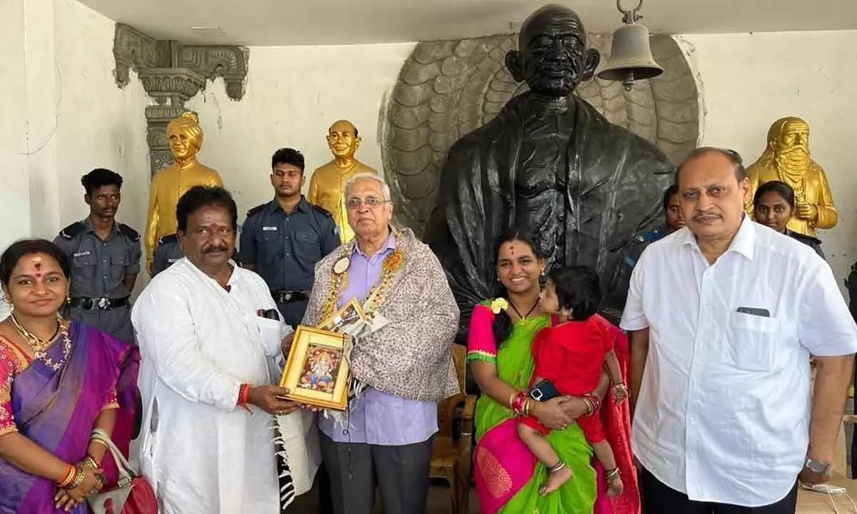 Founder of Mahatma Gandhi temple Rampilla Jayaprakash presenting a memento to retired IAS officer D Chakrapani at a meeting in Vijayawada on Friday. Andhra Arts Academy president Golla Narayana Rao is also seen