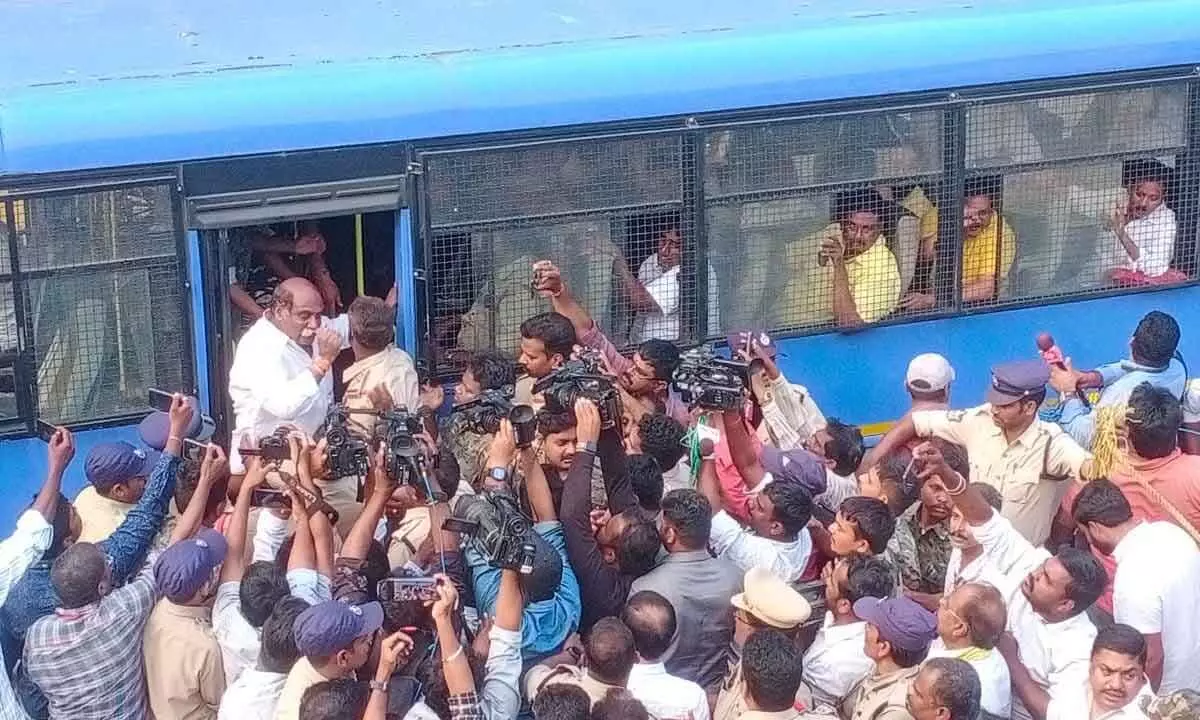 Police taking TDP MLA Velagapudi Ramakrishna Babu into custody in Visakhapatnam on Friday
