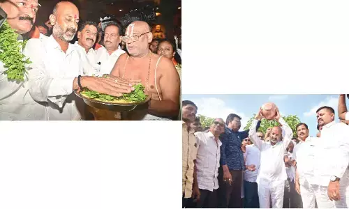 Bandi takes oath at Yadadri, dares KCR to do the same