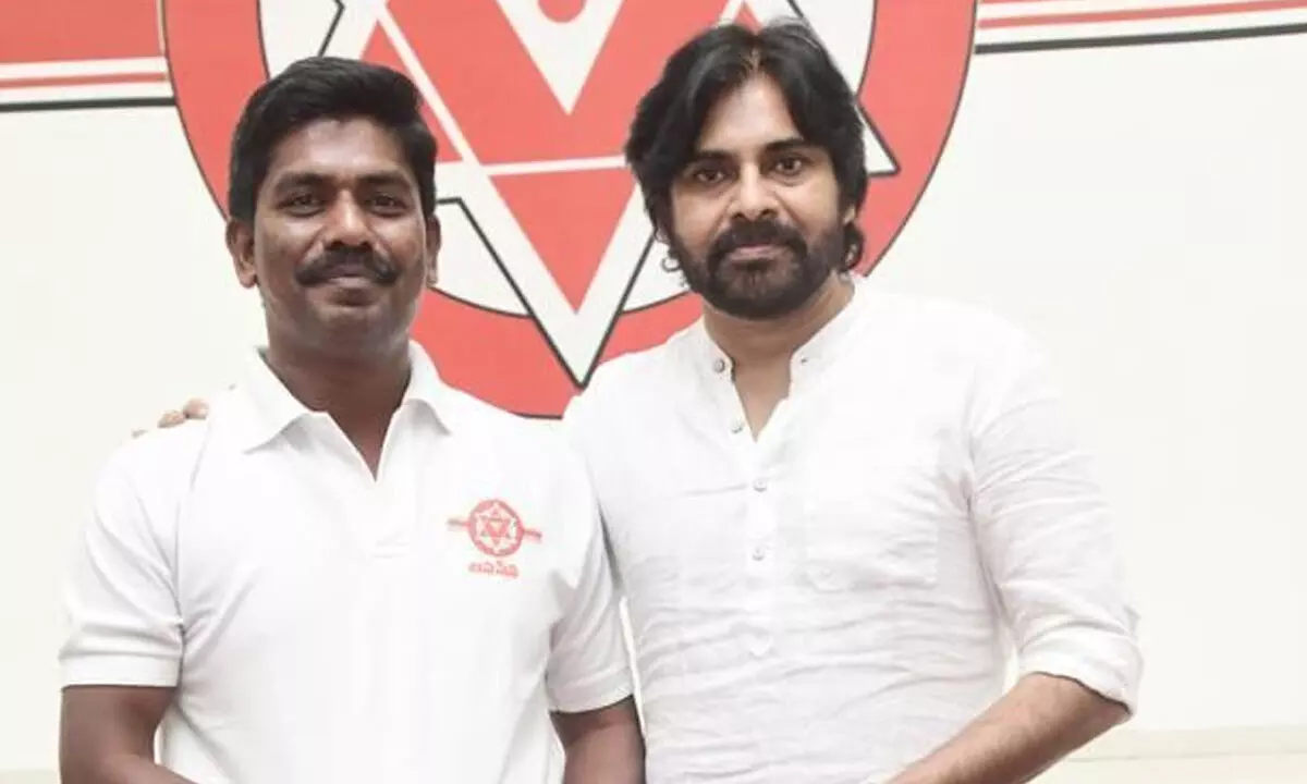Jana Sena Party corporator P Murthy Yadav handing over a cheque to the party president Pawan Kalyan in Visakhapatnam on Sunday