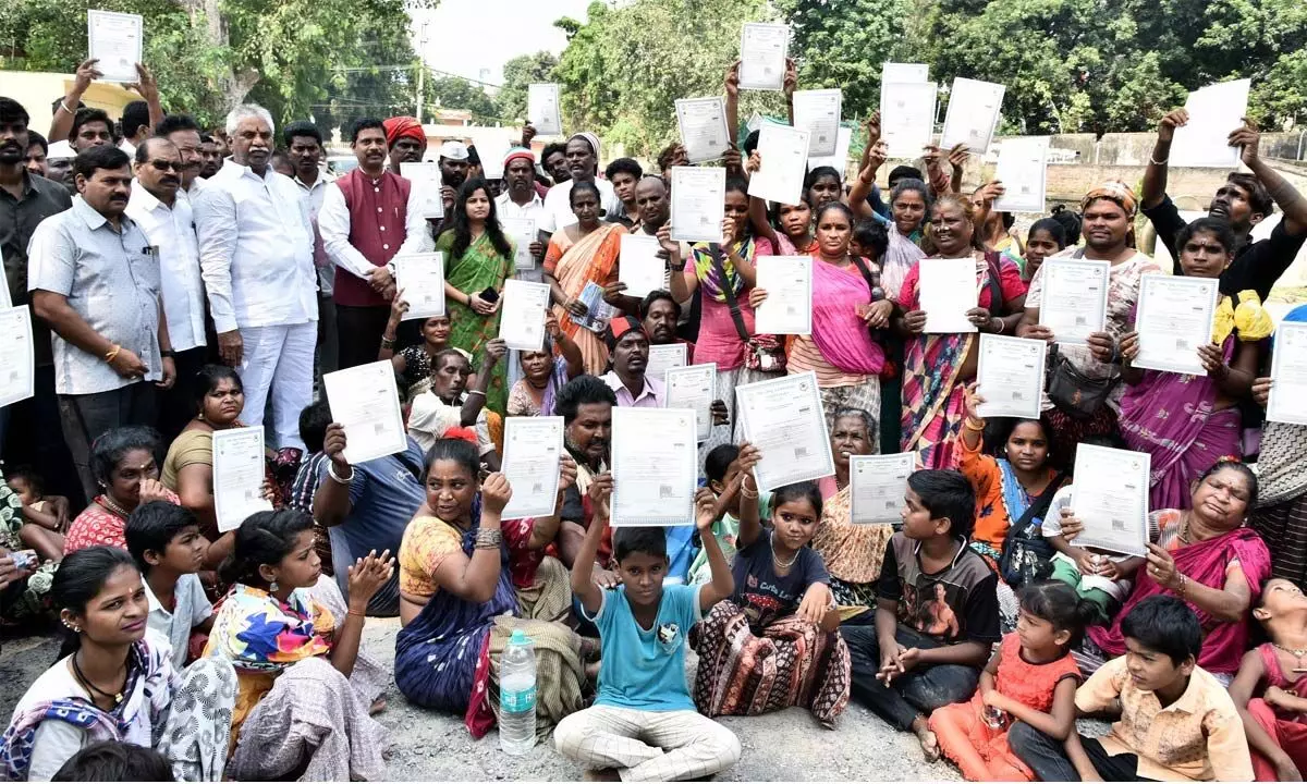 District Collector Dilli Rao, MLAs Malladi Vishnu and Velampalli Srinivasarao giving ST certificates to Nakkala families in Vijayawada on Monday